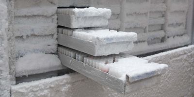 Freezer of samples with sample drawers open and coated in frost