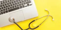 A stethoscopy and the corner of a laptop keyboard