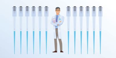Daniel the Clinical Lab Guy stands smiling among a row of pipettes