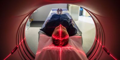 Patient lying inside a medical scanner in hospital