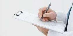 hands writing on a clipboard