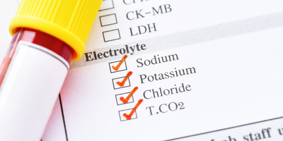 A tube of blood next to a list of electrolytes 