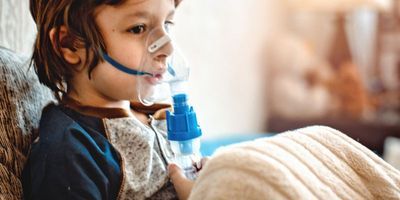A child wearing an asthma inhaler