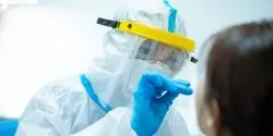 clinical professional wearing PPE taking a covid-19 swab