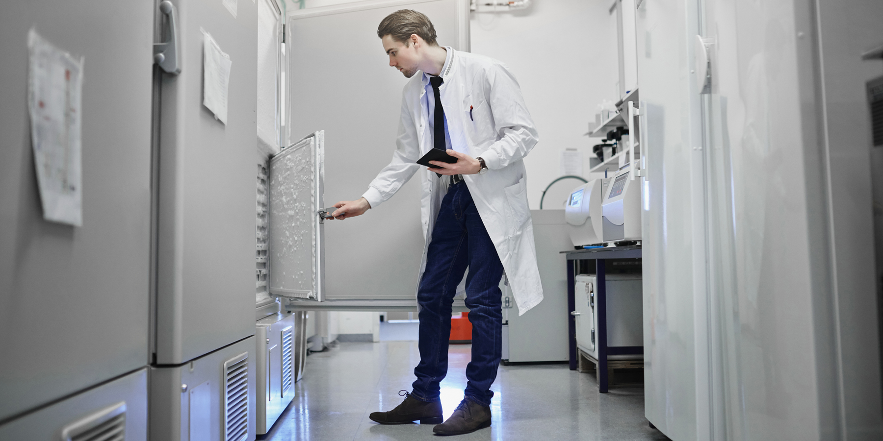 clinical laboratory technician inspecting ultralow temperature freezer clinical laboratory technician inspecting ultralow temperature freezer