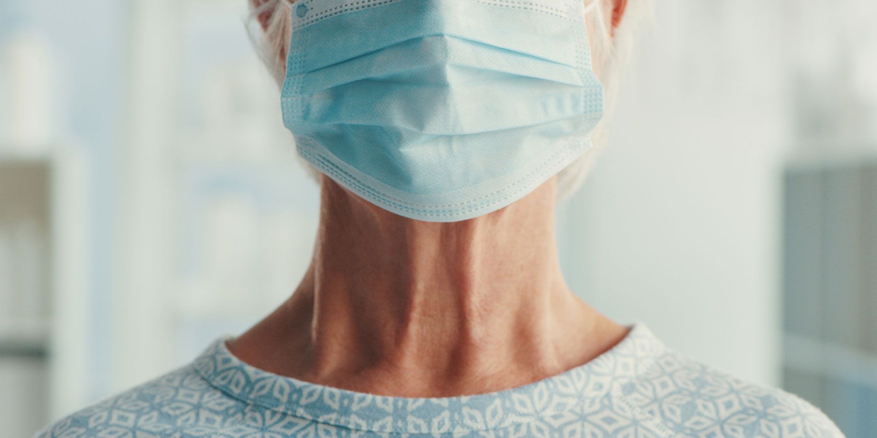 Patient wearing a hospital gown and a surgical call