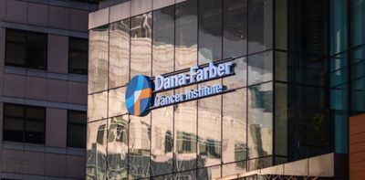Photograph of the outside building of the Dana-Farber Cancer Institute. A sign with the institutes name is mounted in the front of the building.