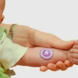 Photo of a baby wearing the "sweat sticker" on its arm