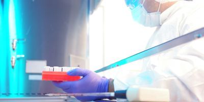 Photo of a lab professional wearing PPE and working with cancer ctDNA in a biological safety cabinet