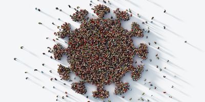 Aerial view of a group of people standing on a white background in the shape of the coronavirus