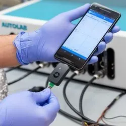 Laboratory professional wearing gloves holds the rapid COVID-19 biosensor test in their hands
