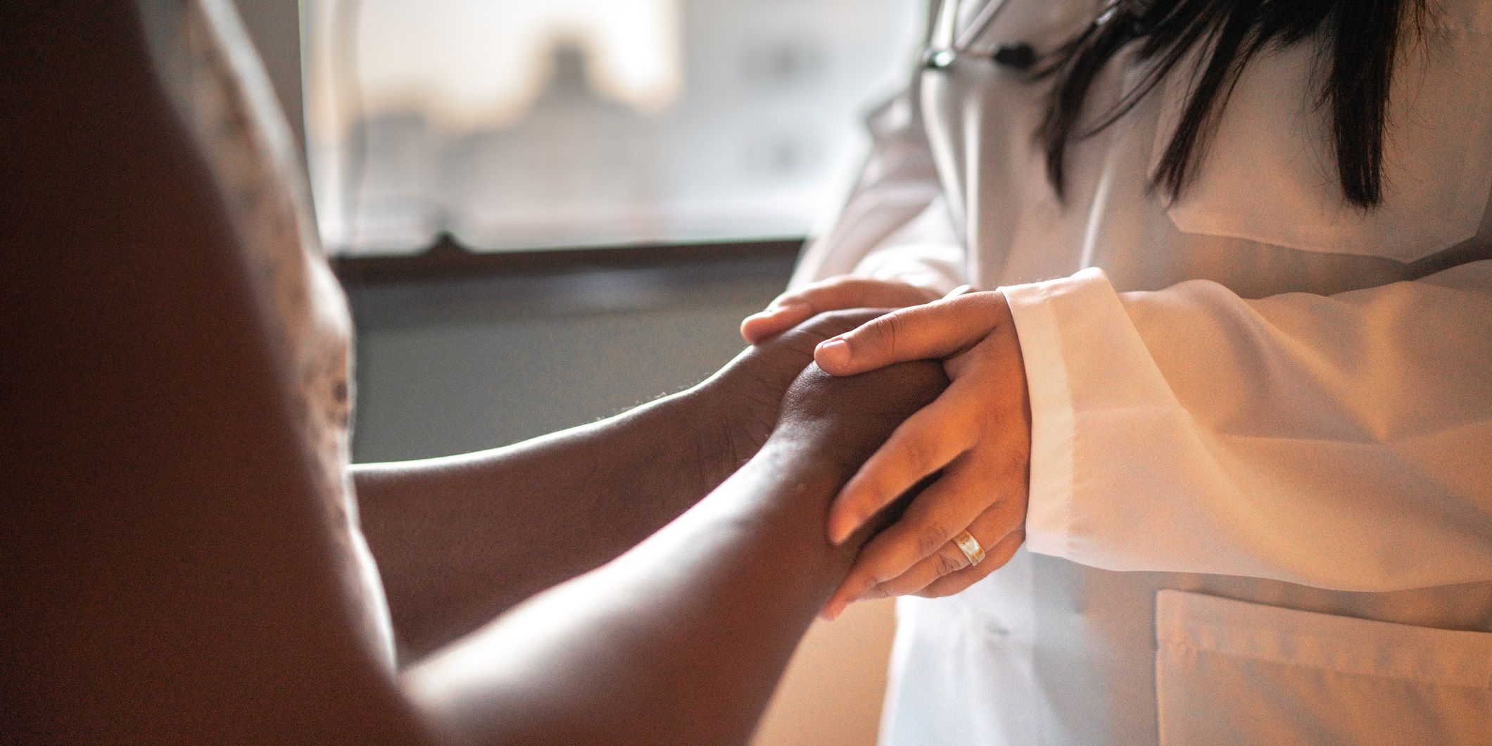 Ethnic Diversity Helps Identify More Diabetes-Related Traits Photo of a laboratory professional holding the hands of a patient