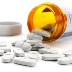 Image of pills falling out of pill bottle
