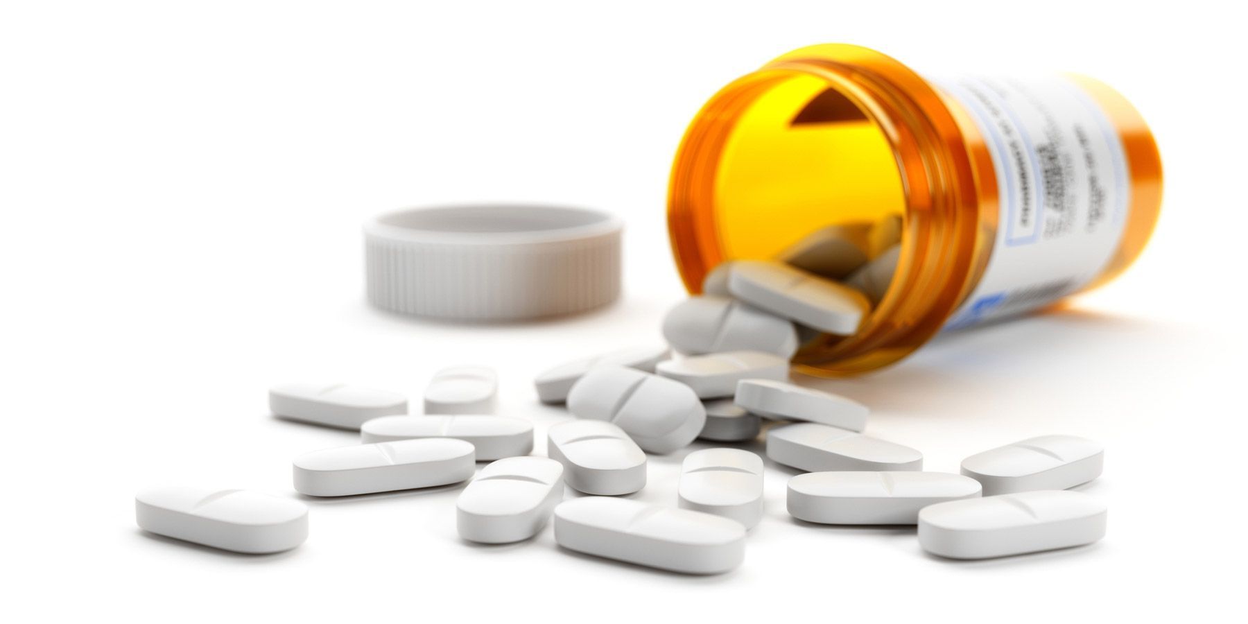 Image of pills falling out of pill bottle