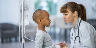 Young girl getting cancer treatment from doctor