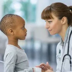 Young girl getting cancer treatment from doctor