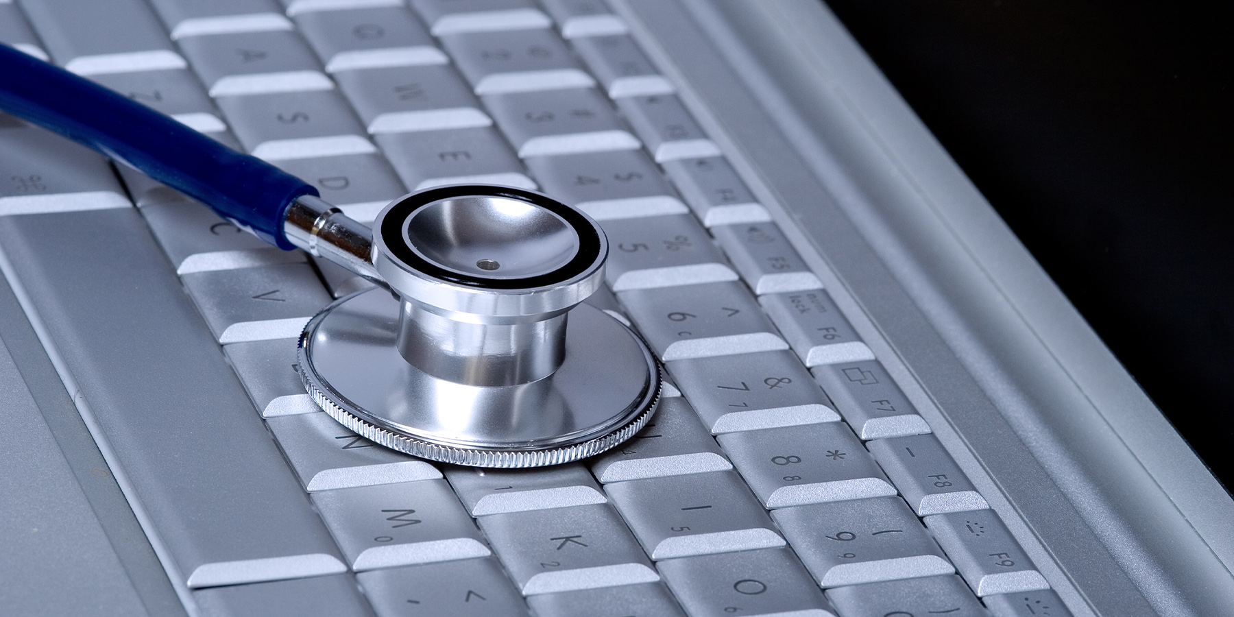 Stethoscope lying on computer keyboard
