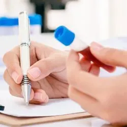 Researcher holding vial of blood for testing
