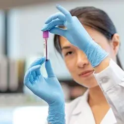 Researcher looking at blood sample