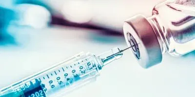 Image of a needle withdrawing fluid from a bottle