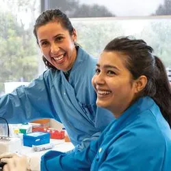 Photo of two laboratory professionals in the lab