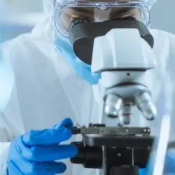 Researcher looking in microscope