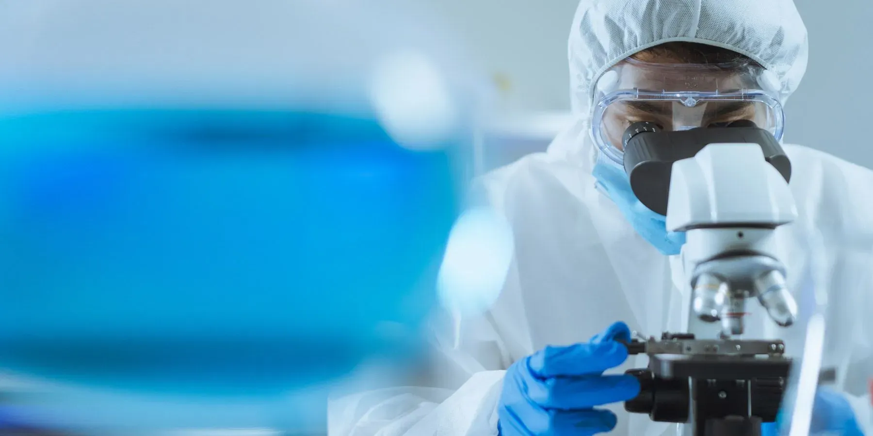 Researcher looking in microscope