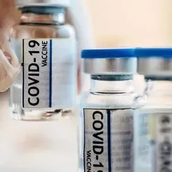 Researcher placing Coronavirus vaccine bottles