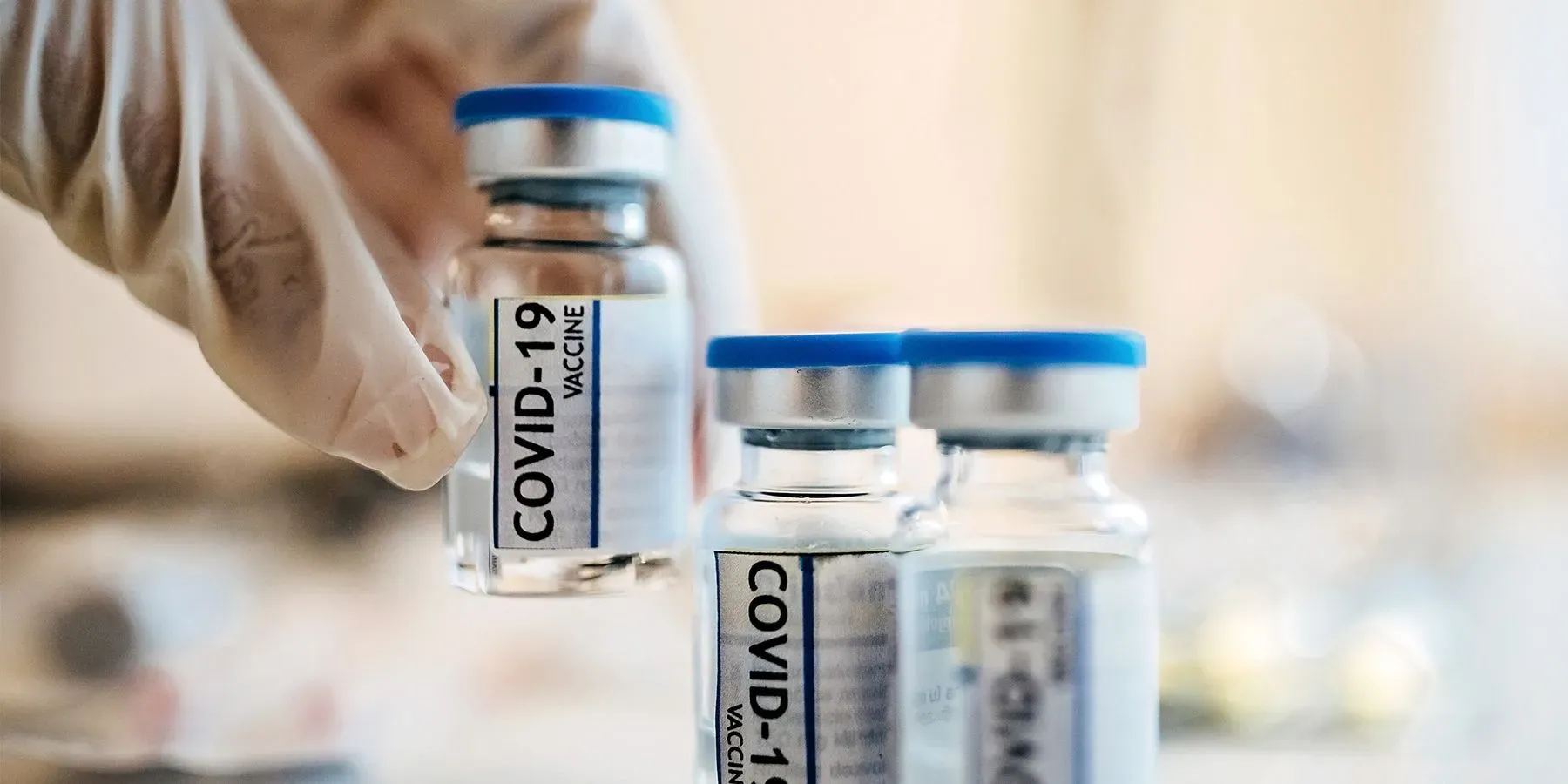 Researcher placing Coronavirus vaccine bottles