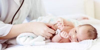 Baby being screend by a health care professional 