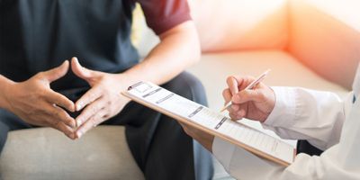 Image of a health care provider speaking with a patient 