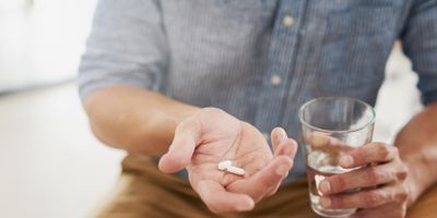 Man holding pills