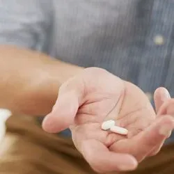 Man holding pills