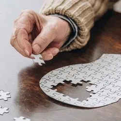 Image of elderly man working on a puzzle