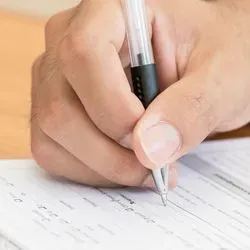 Researcher writing down notes on a pad