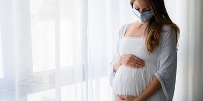 Pregnant woman wearing a mask