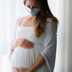 Pregnant woman wearing a mask