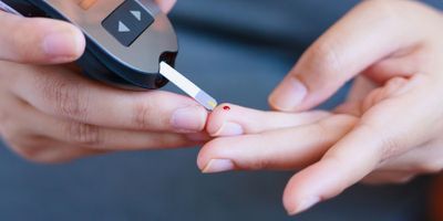 Diabetic taking blood glucose measurement