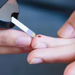 Diabetic taking blood glucose measurement