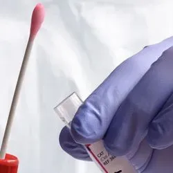 Image of a researcher holding a COVID-19 Test