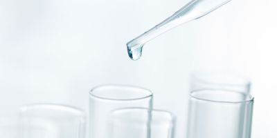 Photo of Milli-Q water being pipetted into a clinical lab sample