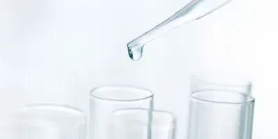 Photo of Milli-Q water being pipetted into a clinical lab sample