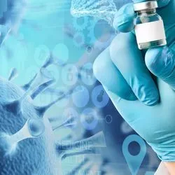 A clinical laboratory professional holds up a vial biotherapeutic for infectious diseases