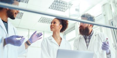 A photo of clinical laboratory professionals wearing PPE standing in the lab during their clinical internship