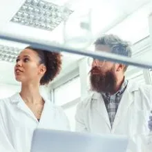 A photo of clinical laboratory professionals wearing PPE standing in the lab during their clinical internship
