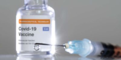 A covid-19 vaccine bottle and needle