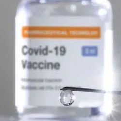 A covid-19 vaccine bottle and needle