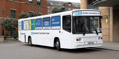 Photo of a National Health System mobile vaccination clinic bus