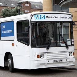 Photo of a National Health System mobile vaccination clinic bus