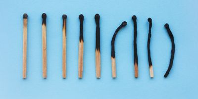 A photo of burnt matches against a blue background